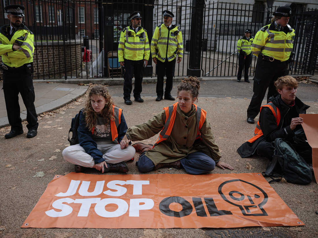 LONDON, ENGLAND - OCTOBER 12: Just Stop Oil protesters block the road at the back of Downing Street on October 12, 2022 in London, England. Two groups of environmental protesters, Just Stop Oil and Insulate Britain, demonstrated in Westminster today, on the day the prime minister attended PMQs. Just Stop Oil protesters claim that dependence on oil and gas has caused the cost of living crisis and are demanding that the government issue no new licences for fossil fuels, no fracking and continued rights to strike for workers. (Photo by Rob Pinney/Getty Images)