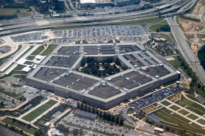 Aerial view of the Pentagon complex with surrounding roads, parking and greenery. g